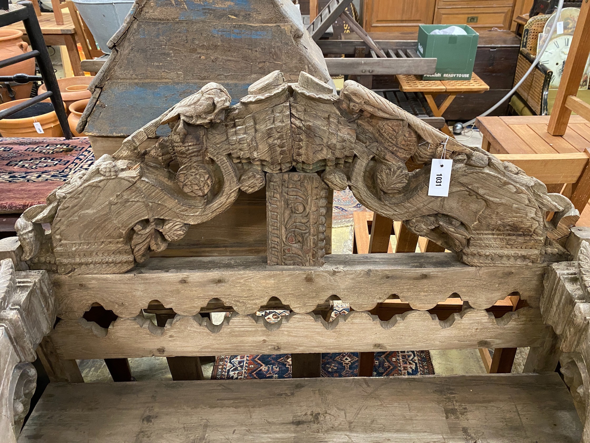 An Indonesian bleached carved hardwood bench seat, length 124cm, depth 50cm, height 111cm